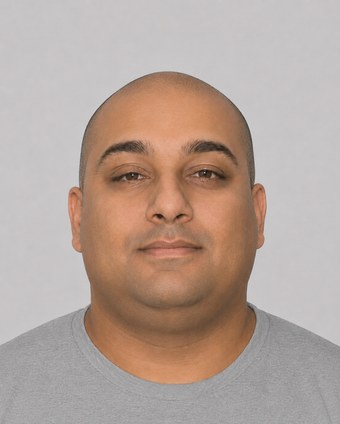 Computer-generated image showing Joseph Tennis with a shaved head and clean-shaven, front facing, plain grey background.