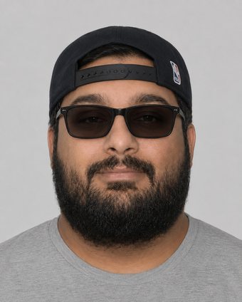 Computer-generated image showing Joseph Tennis wearing a dark backwards baseball cap and sunglasses, with a full beard, plain grey background.